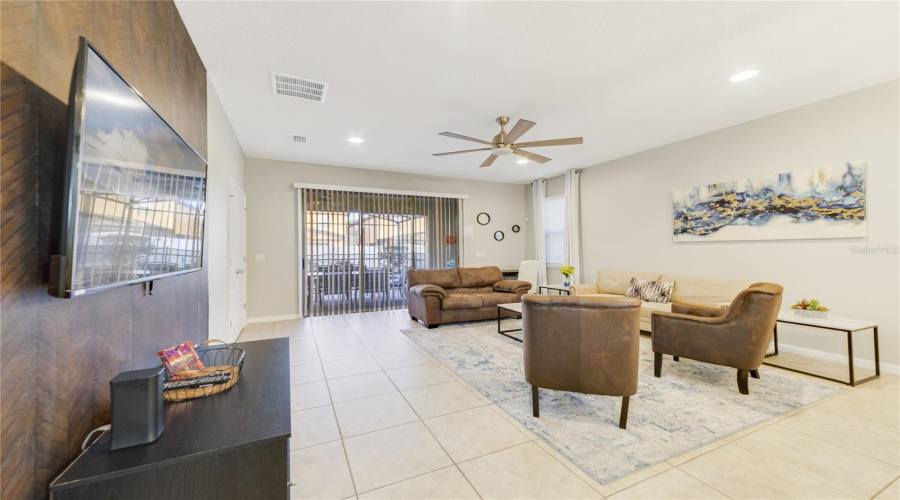 Modern ceramic tile floors, bright natural light, and an ELEGANT ACCENT WALL in the Living Room create a warm, contemporary ambiance.