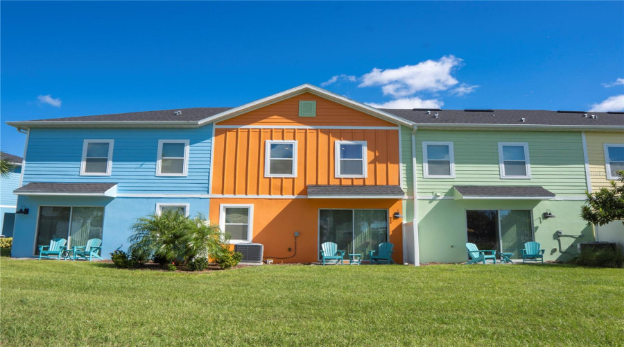 Spacious backyard view with private patio seating — relax and unwind in this tropical Margaritaville retreat near Disney.