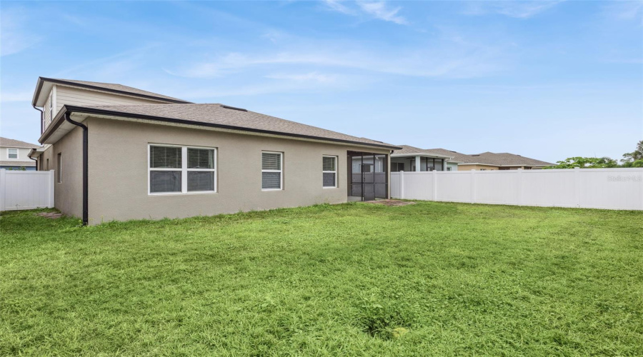 Spacious backyard and privacy fence.