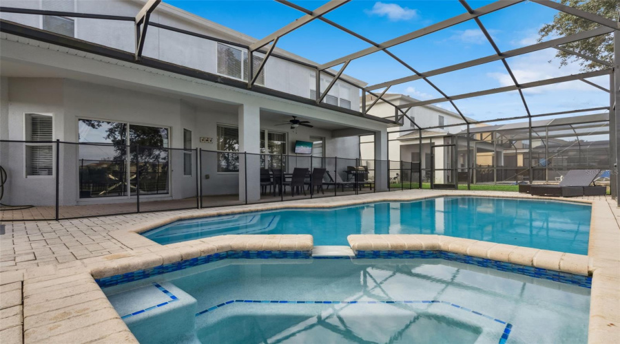 Large pool with hot tub and lounging area