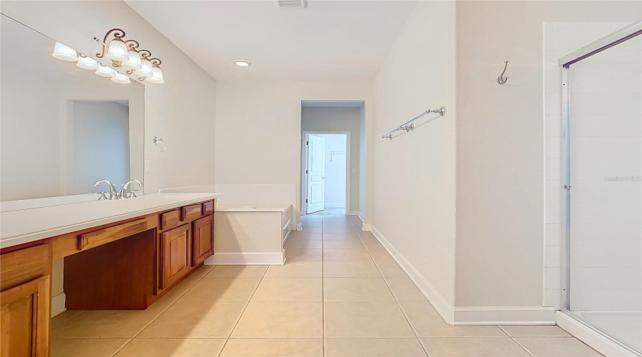 A wonderful sized bathroom with a garden tub, separate showerr stall, water closet, linen closet, and walk-in closet.