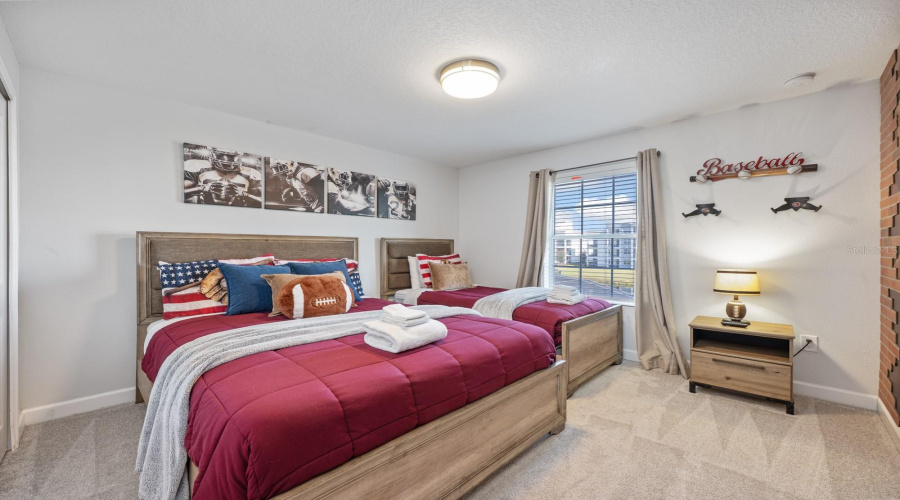 Two additional CARPETED bedrooms—one thoughtfully decorated with a Disney theme and the other with a sports theme add excitement and fun. Bedroom 3