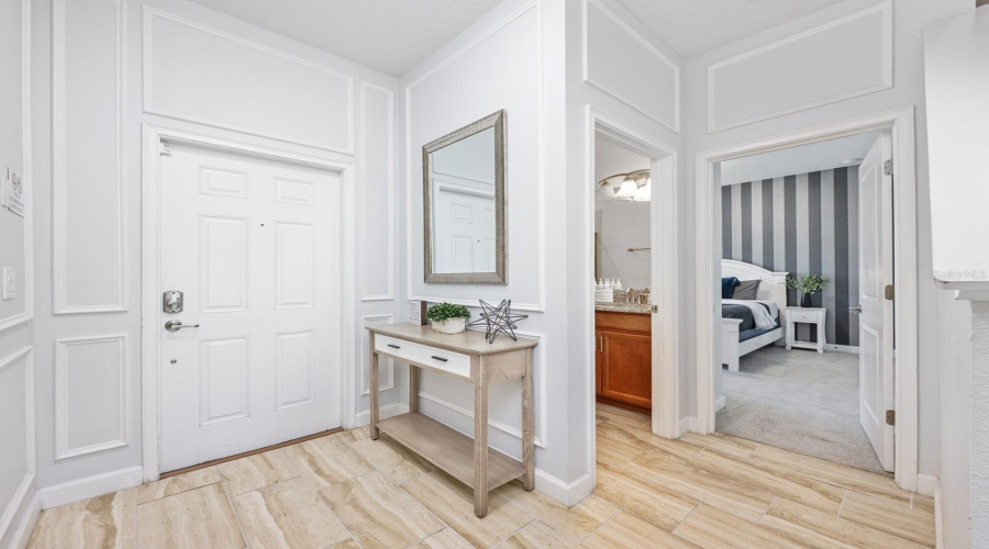 The OPEN-CONCEPT main level is designed for effortless entertaining, featuring stylish ceramic tile flooring throughout and picture-frame molding graces the hallway walls.