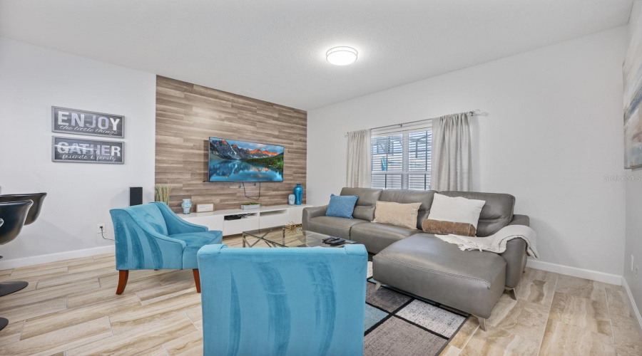 Bright and welcoming is the spacious Living Room with a MODERN ACCENT WALL.