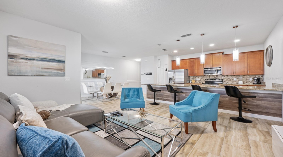 An open floorplan allows for effortless movement from the Living Room to the connected Dining area and Kitchen.