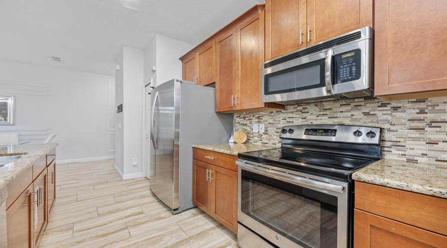 Centrally located, the open Kitchen features abundant cabinet storage and counter space.