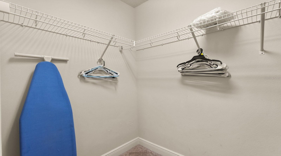 Walk-in closet in primary bedroom