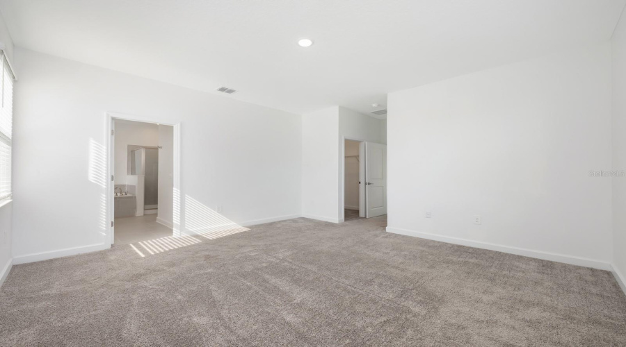 The Primary Suite is a true sanctuary, featuring TWO WALK-IN CLOSETS and a beautifully appointed en suite bath with a dual-sink quartz vanity, SOAKING GARDEN TUB, step-in shower, and private water closet—a spa-like escape at the end of the day.