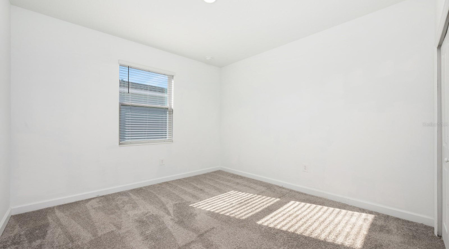 Three additional bedrooms, including one with a private en suite bath, provide versatile living options for guests, family, or work-from-home needs. Bedroom 2.