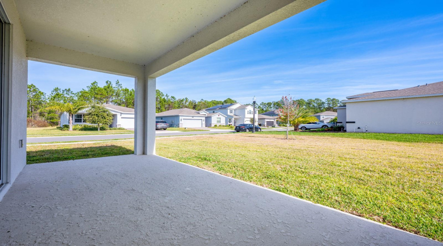 Sliding glass doors from the living area open to a covered rear porch and an EXPANSIVE BACKYARD, for relaxing evenings and weekend enjoyment.
