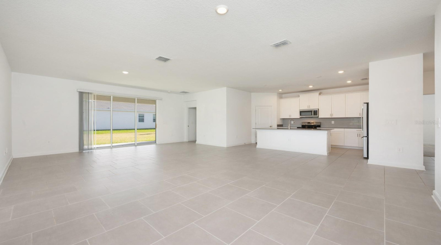 Sleek tile flooring spans the main living areas, while plush carpeting in the bedrooms adds warmth and retreat-like comfort.