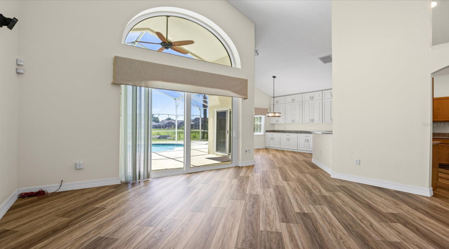 Family room with view of pool and water