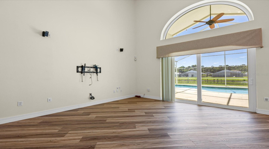 Family room with view of pool and water