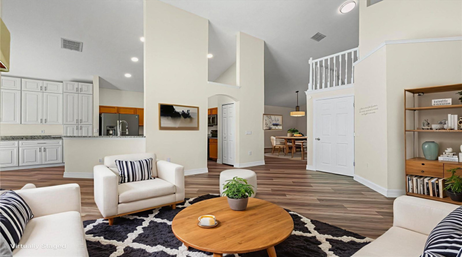 Family room with view into the kitchen - virtually staged