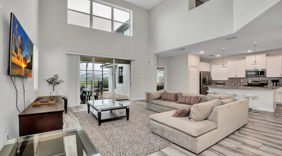 Living room with vaulted Ceillings and pool and pond view