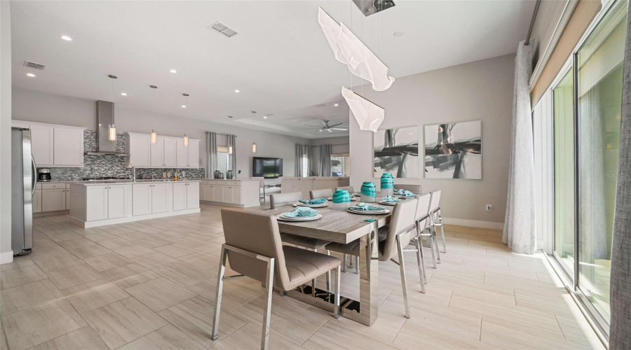 A spacious open-concept living area seamlessly connects the kitchen and dining spaces, perfect for entertaining and guest enjoyment.
