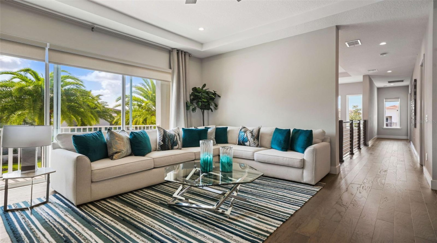 Designed for entertainment, the home includes a game room and a private theater with tiered seating, projection screen, ceiling-mounted projector, and surround sound, delivering an authentic in-home cinema experience.