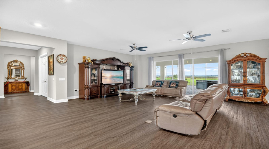 Spacious family room with large windows and sliding doors overlooking the lake.