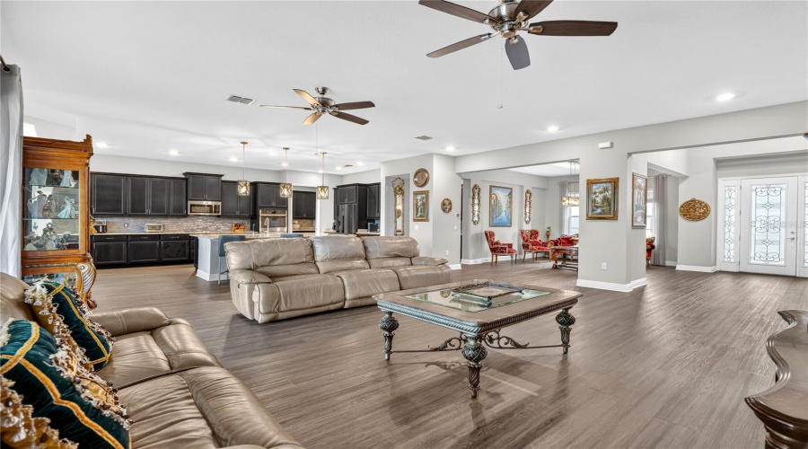 Spacious open-concept living area with tile flooring and flexible layout.