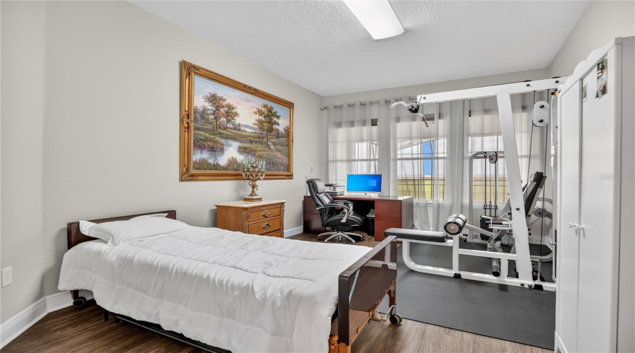 Versatile bedroom or office with natural light and room for multiple uses.