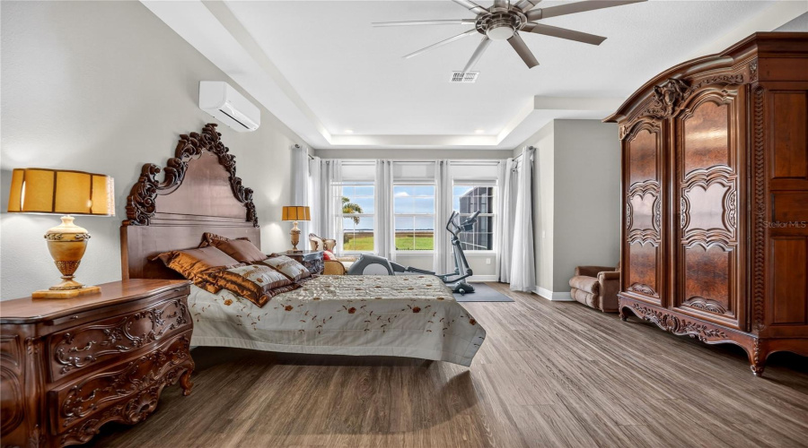 Primary bedroom showcasing lake views and generous floor space.