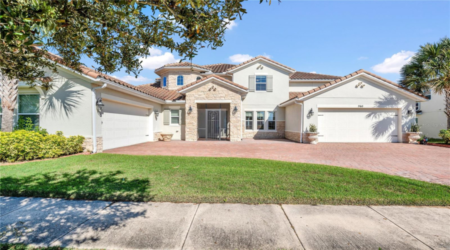 Front elevation highlighting stone accents, tile roof, and screened entry.