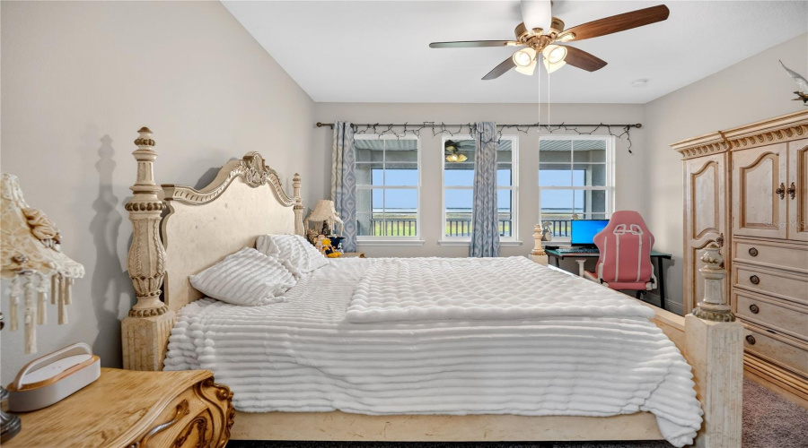 Junior primary bedroom featuring multiple windows and lake views.