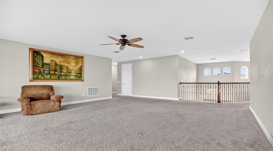 Loft or game room showcasing expansive space suitable for multiple uses.