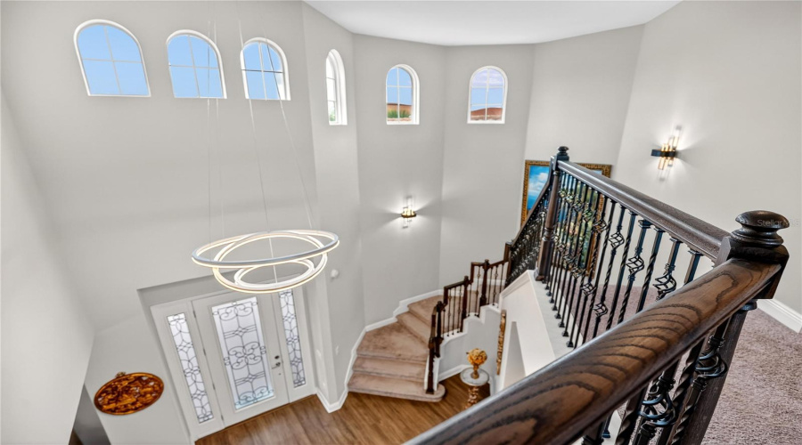 Upper-level overlook with arched windows and staircase views.