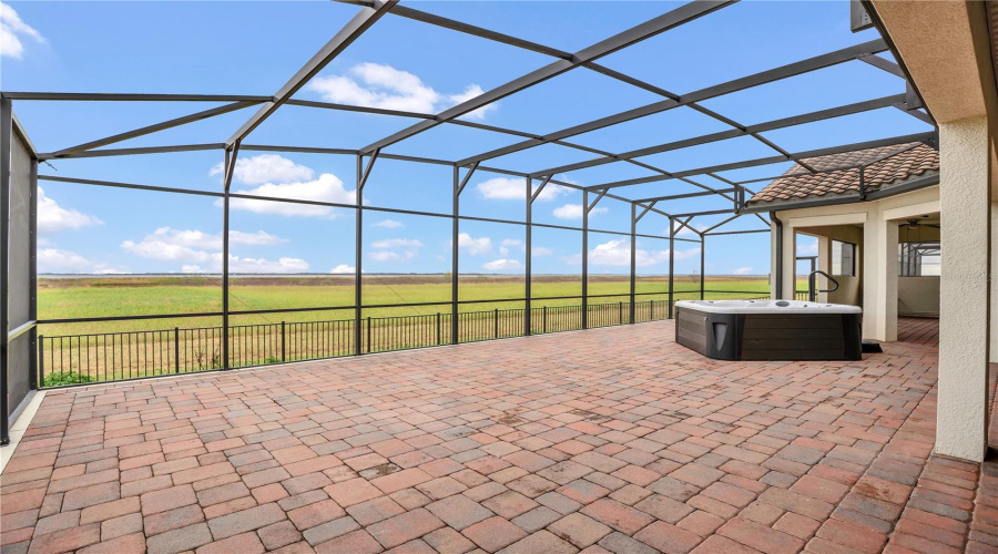 Covered lanai overlooking lake and conservation beyond
