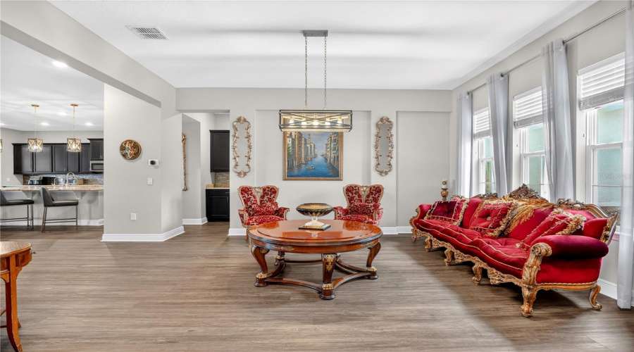Formal sitting area with open layout and adjacent kitchen views.