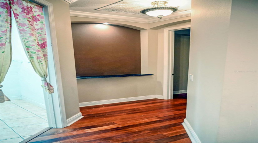 Hallway leading to the mater bedroom has an inside for art and a light to really display your favorite piece. Note the laundry room to the left.