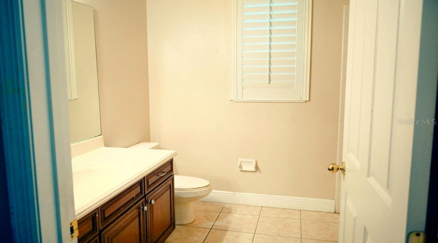 Hall bathroom with single sink and tub with shower.