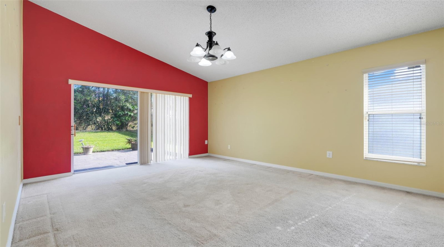 The dining room features sliding glass doors out to the pavered/tiled patio. (New flooring and paint since original photos were taken)