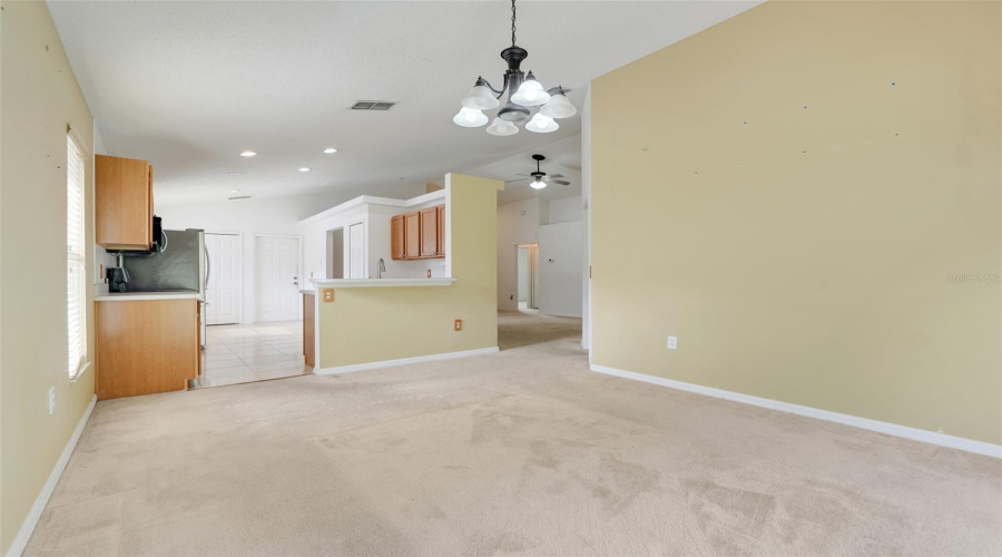 The kitchen is just off the dining room making meal prep and meal time a seamless transition. (New flooring and interior paint since original photo was taken)