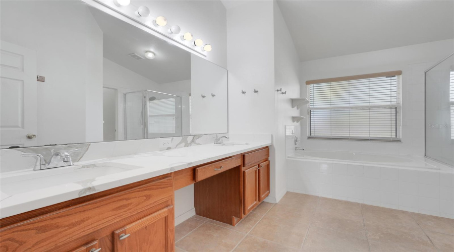 Enjoy this spacious primary bath featuring dual sinks, a soaking tub with separate shower, and private water closet.