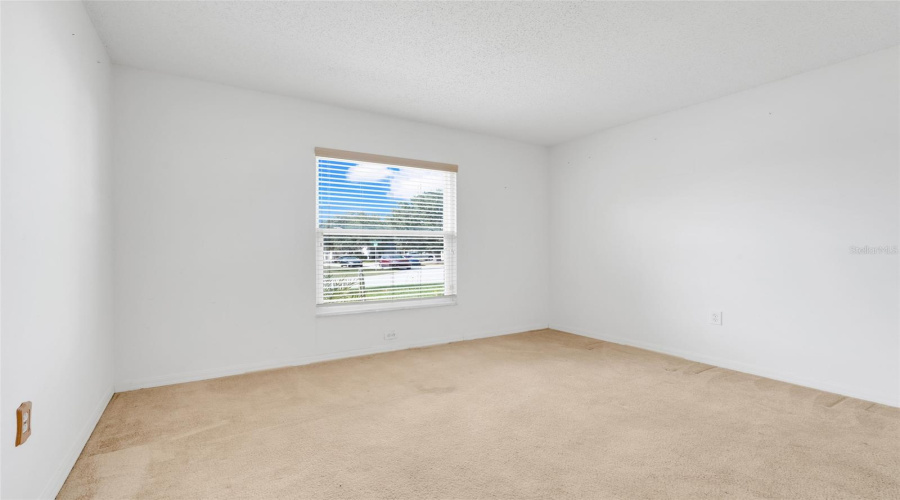 Bedroom 2 is located at the front of the home and offers a built-in closet. (New flooring and paint since photo was taken)