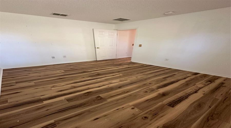 Bedroom 3 with updated flooring and paint.