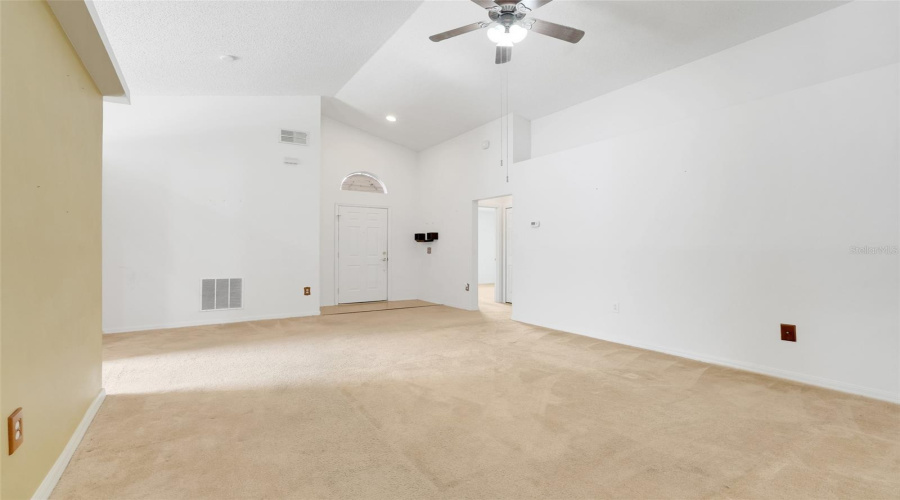 The living room offers three sizeable walls allowing for multiple furniture arrangements and space to hang your TV or favorite artwork. (New flooring and paint since original photos were taken)