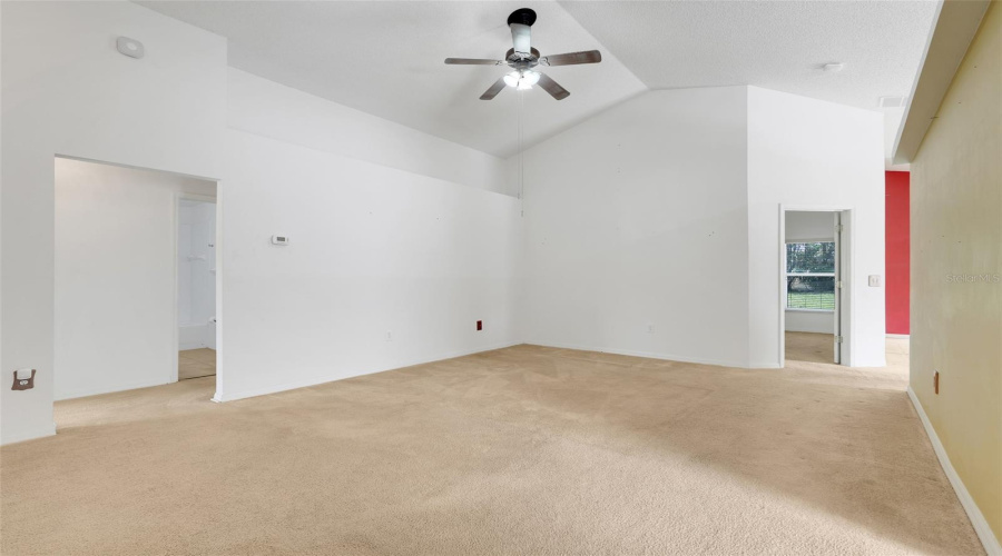 Love the high ceilings! This space also flows to the kitchen and dining room. (New flooring and interior paint since original photo was taken.)