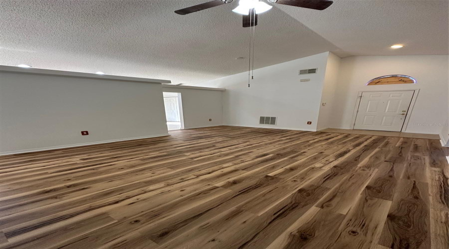 Living room with updated flooring and paint.