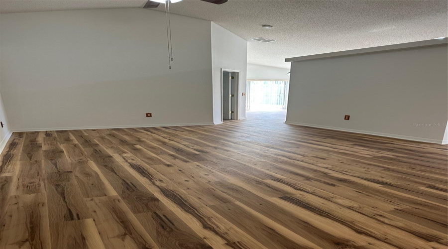 Living room with updated flooring and paint.