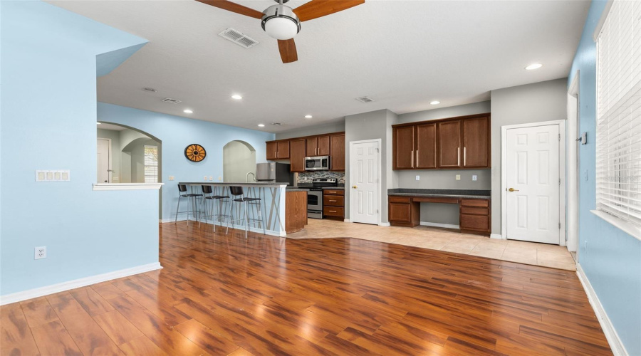 View of Living Room, Built in Desk, and Kitchen areas.