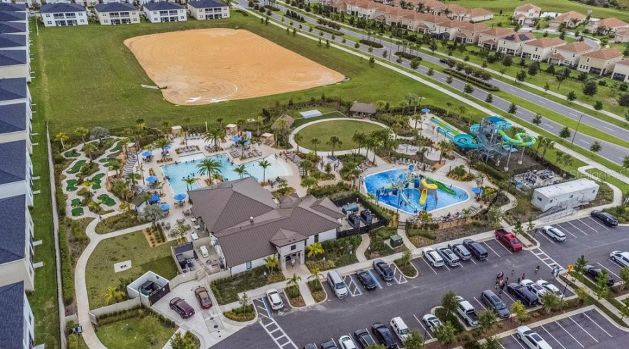 Aerial view of  community pool with water park at Oasis Clubhouse