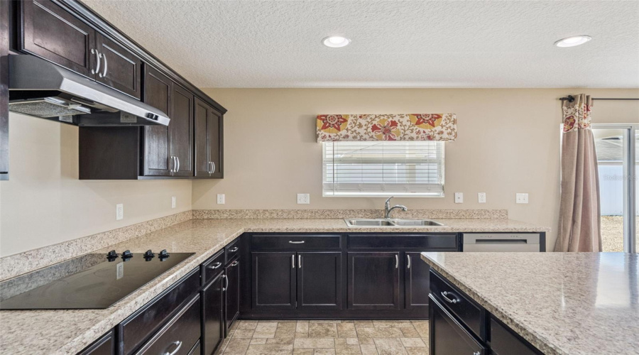 Hood vents out, electric cook top w/large pot drawers underneath