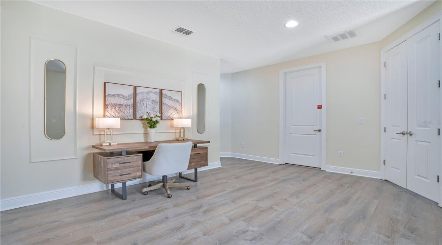 Spacious upper-level loft offering additional gathering or workspace flexibility