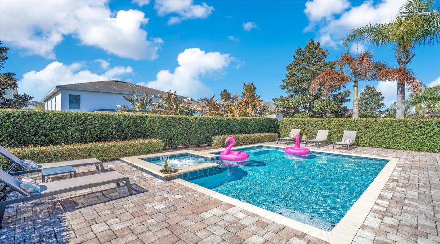 Resort-style screened pool area offering privacy, sunshine, and seamless indoor-outdoor living