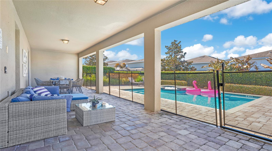 Spacious covered outdoor lounge area designed for shaded relaxation and year-round enjoyment