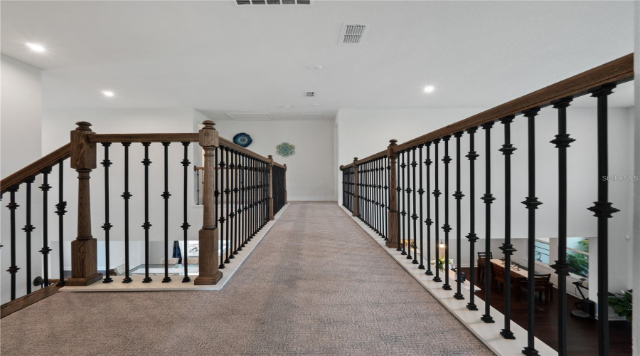 Catwalk dividing the guest suite and loft and theater room