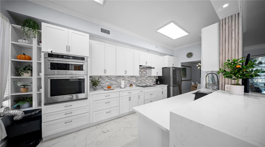 Kitchen - Quartz Countertops and Stainless Steel Appliances featuring Select Kitchen Aid Units